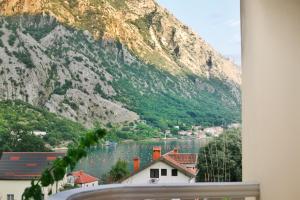 a view of a mountain and a lake from a window at Apartman Vujović Orahovac in Trstenik