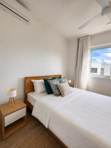 a bedroom with a large bed and a window at Blue Zebra - Le West 24 in Tamarin +19 photos