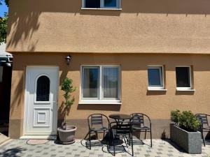 a patio with chairs and a table in front of a building at Apartment Herceg Blagaj in Blagaj