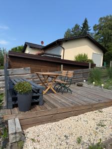 a wooden deck with a bench and a chair on it at Moderne Ferienwohnung mit guter Ausstattung und Self checkin in Bodenwerder