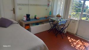 a bedroom with a bed and a table and a table and chairs at B&B Iris in Conca dei Marini