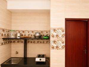 a kitchen with a sink and a counter top at C Gowri Lodge in Vellore