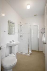 a bathroom with a toilet and a shower and a sink at Ashley Victoria in Blackpool +27 photos
