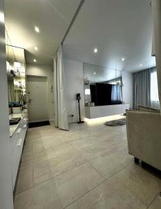 a living room with a couch and a television at Білі апартаменти in Dnipro +11 photos