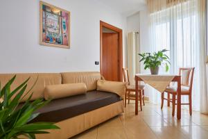 a living room with a couch and a table at Residence Fellini in Rimini