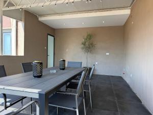 a dining room with a wooden table and chairs at Cardinal Rooftop Townhouse by Aureum in Birgu