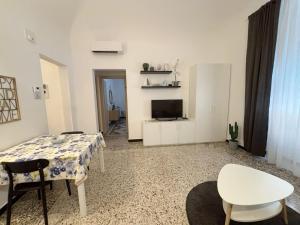 a living room with a table and a tv at Albatros in Savona