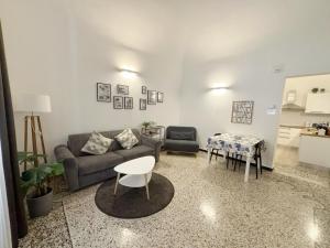 a living room with a couch and a table at Albatros in Savona