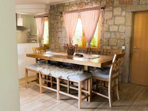 a dining room with a wooden table and chairs at Green Forest in Žabljak