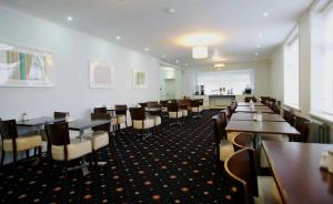 a dining room filled with tables and chairs at Ashley Victoria in Blackpool