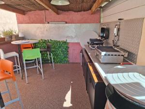 a kitchen with a counter and a table and chairs at La Milhaud in Milhaud