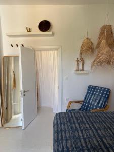 a bedroom with a bed and a mirror and a door at St Pauls Batsi in Batsi +26 photos