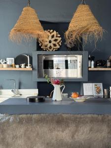 a kitchen with a counter with a sink and a microwave at St Pauls Batsi in Batsi