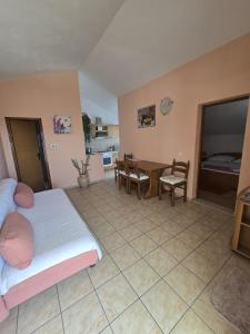 a bedroom with a bed and a dining room at Apartments and Rooms Jasna in Hvar
