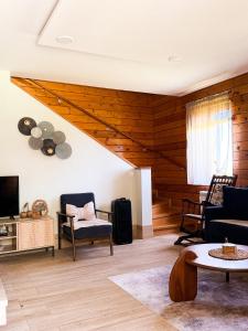 a living room with a couch and a tv at Green Forest in Žabljak