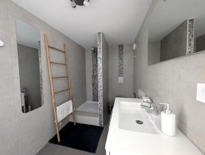 a white bathroom with a sink and a shower at Chez Laurence et Thomas in Cercié +110 photos