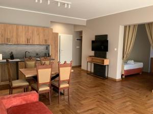 a kitchen and living room with a table and chairs at Ohana Space w Juracie in Jurata