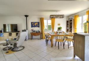 a kitchen and dining room with a table and chairs at Chez Laurence et Thomas in Cercié