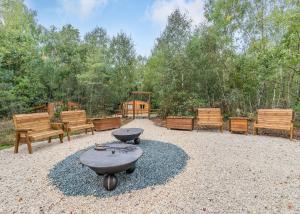a group of benches and a grill in a yard at Quarry Walk Lodges in Cheadle