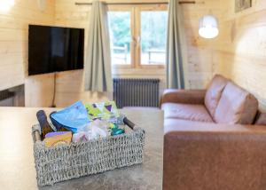 a basket of toys sitting on a table next to a couch at Quarry Walk Lodges in Cheadle +221 photos