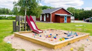 a sandbox with a slide in the sand at Norbergs Camping in Norberg
