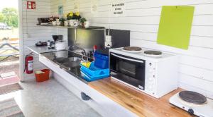 a kitchen with a sink and a microwave at Norbergs Camping in Norberg