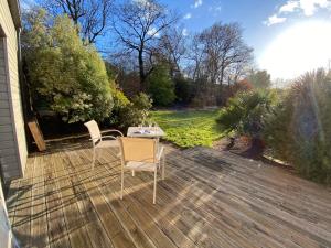 a patio with two chairs and a table on a deck at Le Domaine d'Elissois in Saint-Nicolas-de-Redon +4 photos