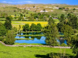 an aerial view of a lake in a field at Rosemount Cottage in Salterforth