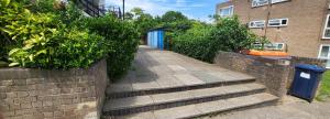 a stairway with a blue door on a brick wall at lovely Studio Flat in The Hyde