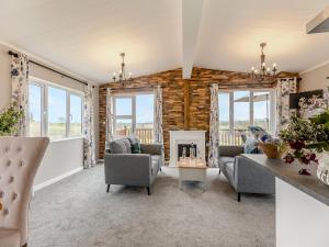 a living room with chairs and a fireplace at Park View - Uk46898 in Kinlet
