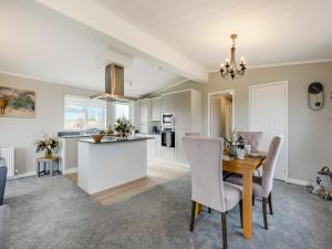a kitchen and dining room with a table and chairs at Park View - Uk46898 in Kinlet