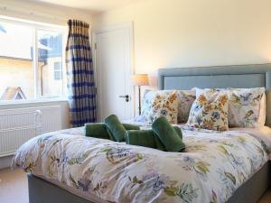 a bedroom with a bed with a large window at Stokewood Annexe in Freshford