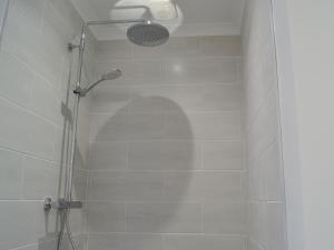 a shower with a glass door in a bathroom at Penmaen in Talgarth