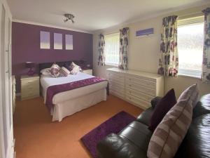 a bedroom with a bed and a couch at Eden - B6526 in Saint Cleer