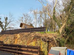 a house on top of a hill with a fence at Lincumtoy in Pinwherry