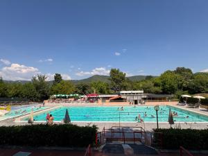 a large swimming pool with people in it at La Specola di Galileo con ampia vasca idromassaggio in Acquasparta