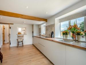 a kitchen with a counter and a window at Manor Cottage in Longham
