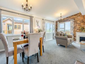 a dining room with a table and chairs and a fireplace at Winnal View - Uk46891 in Kinlet