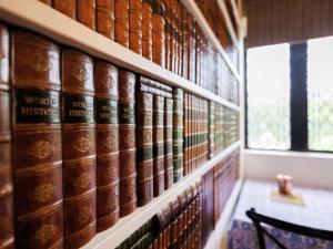 a shelf of books in a library with a bench at The Tower - Uk46652 in Crickhowell