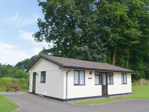 a small white house with a picnic table in a field at Trebah - B5623 in Saint Cleer +7 photos