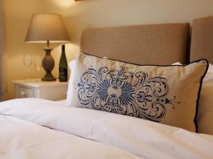 a pillow sitting on top of a bed next to a lamp at The Library - Uk46649 in Crickhowell