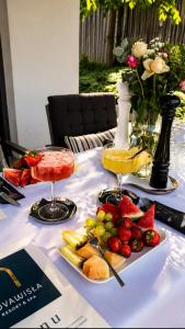 a table with two glasses of juice and fruit on it at NovaWisła Resort & SPA in Wisła