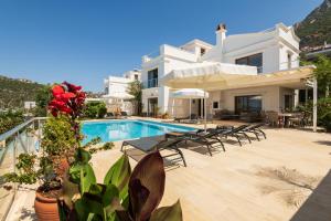 a large white villa with a swimming pool at Villa Yakamoz in Kalkan