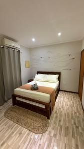 a bedroom with a large bed in a room at Pousada & Hostel América in Barreirinhas