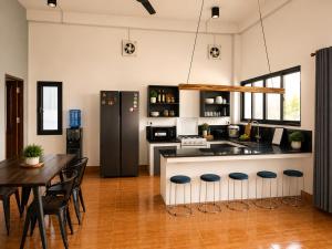a kitchen with a counter and a table with chairs at Casa Primera in Luang Prabang