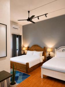a bedroom with two beds and a table at Casa Primera in Luang Prabang