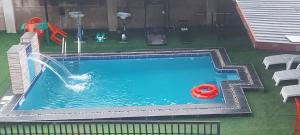 a pool with a water slide and a red toy at Lazeto Hotel & Resort in Zokoja