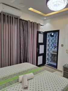 a bedroom with a bed and a door with a mirror at Mamelle in Dakar