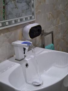 a sink with water coming out of a faucet at Mamelle in Dakar +1 photo