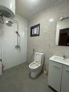 a bathroom with a toilet and a sink at Mamelle in Dakar